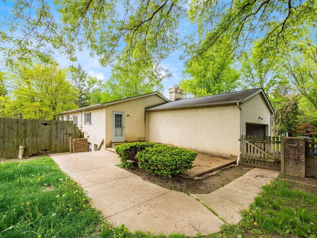 3182 Grey Fox Dr, Columbus, OH 43230 - view of front facade with a gate, stucco siding, a chimney, and fence