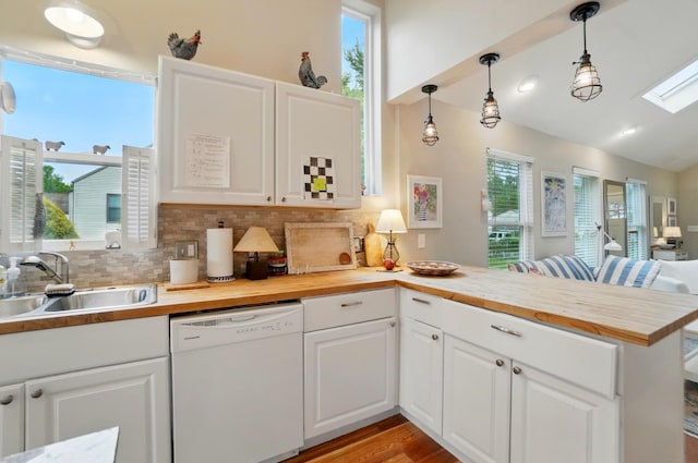 286 Rosslyn Ave, Columbus, OH 43214 - kitchen with dishwasher, a sink, wood counters, a peninsula, and lofted ceiling