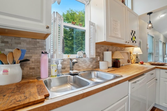 286 Rosslyn Ave, Columbus, OH 43214 - kitchen featuring dishwasher, a sink, white cabinetry, decorative backsplash, and butcher block counters