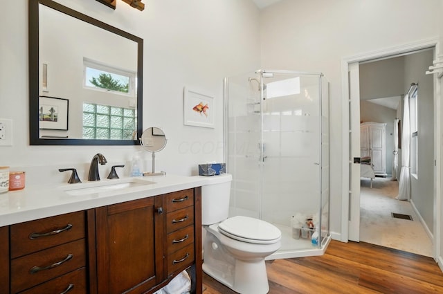 286 Rosslyn Ave, Columbus, OH 43214 - full bathroom featuring a stall shower, vanity, wood finished floors, and toilet