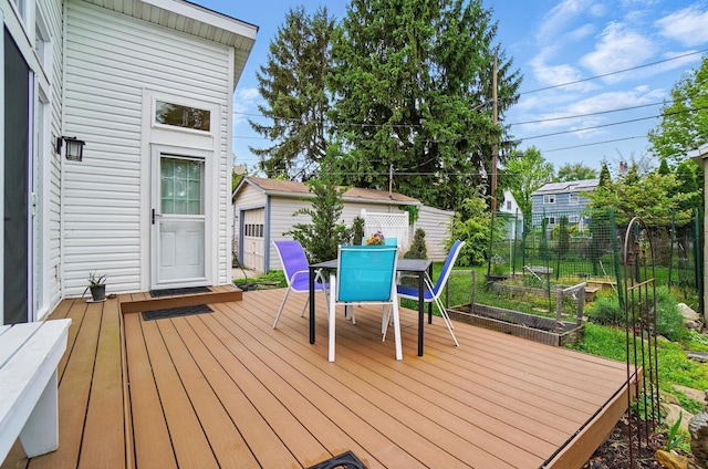 286 Rosslyn Ave, Columbus, OH 43214 - wooden terrace featuring outdoor dining space, a garden, and an outdoor structure