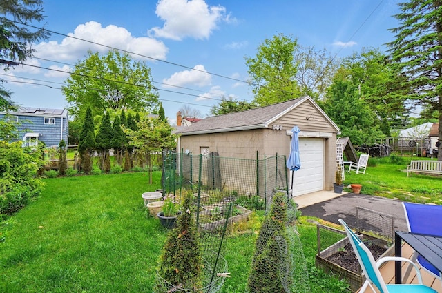 286 Rosslyn Ave, Columbus, OH 43214 - view of yard featuring a garden, a detached garage, driveway, and an outdoor structure