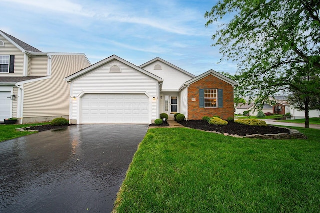 view of front of home featuring driveway, an attached garage, a front lawn, and brick siding