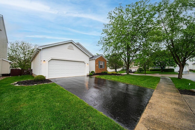 view of front facade with asphalt driveway and a garage