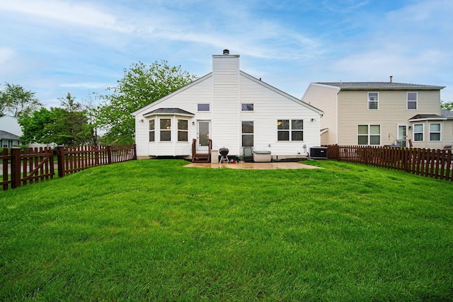 back of house featuring a chimney, a patio area, and central AC unit