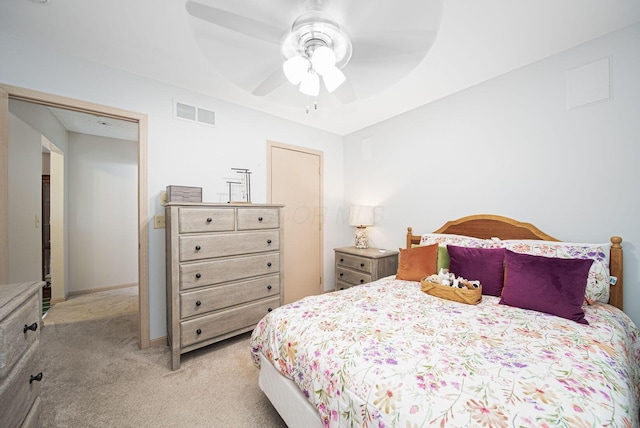bedroom featuring light carpet, a ceiling fan, and baseboards