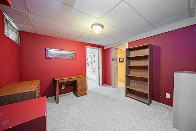 unfurnished bedroom featuring a drop ceiling and carpet flooring