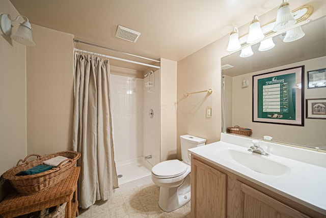 bathroom featuring toilet, a shower stall, and vanity