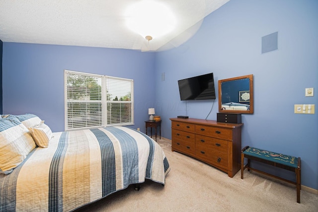bedroom featuring carpet, lofted ceiling, and baseboards