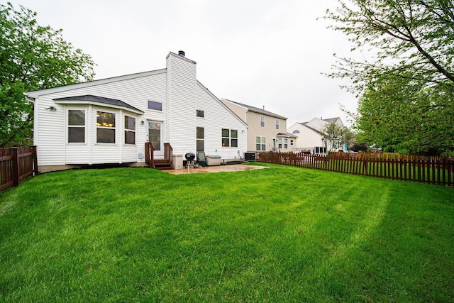 back of property featuring a chimney, a patio, entry steps, and cooling unit