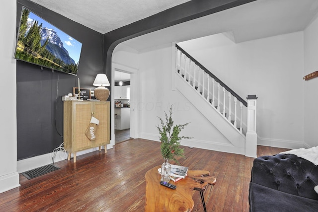 1096 Church St, Logan, OH 43138 - living room featuring stairs, hardwood / wood-style flooring, baseboards, and arched walkways