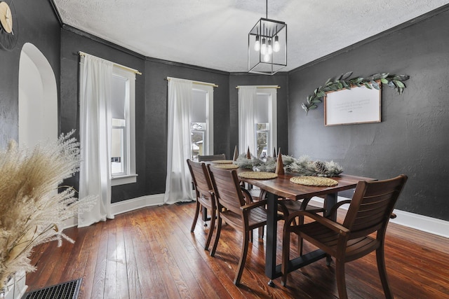 1096 Church St, Logan, OH 43138 - dining room with wood-type flooring, baseboards, a chandelier, and a textured wall