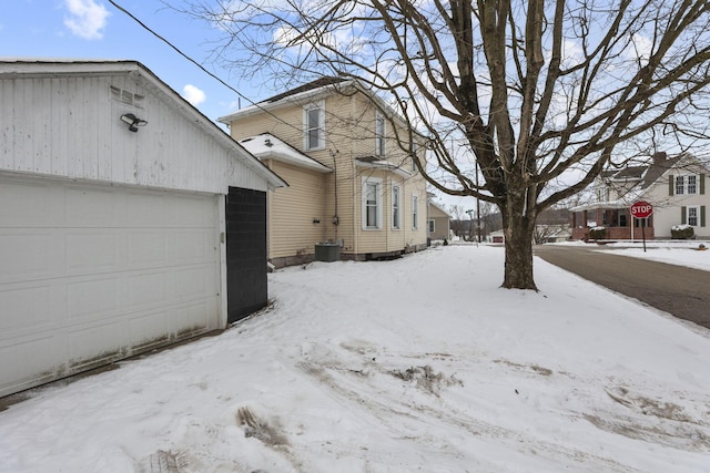 1096 Church St, Logan, OH 43138 - view of snowy exterior featuring a garage and an outbuilding