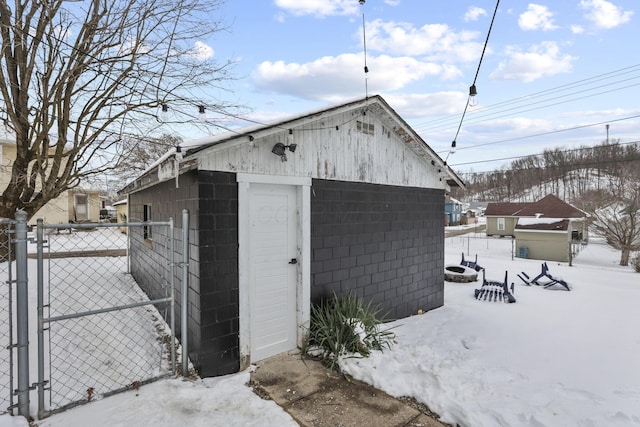 1096 Church St, Logan, OH 43138 - snow covered structure featuring a gate, fence, and an outbuilding