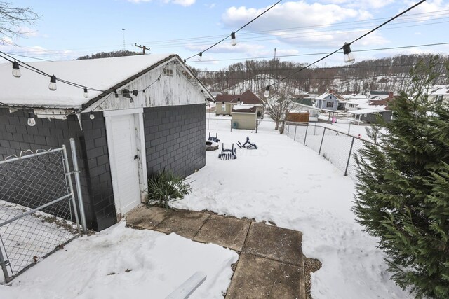 1096 Church St, Logan, OH 43138 - snow covered structure featuring a fenced backyard, an outbuilding, and a storage unit