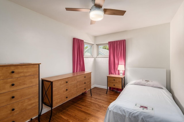 bedroom featuring wood finished floors, baseboards, and ceiling fan