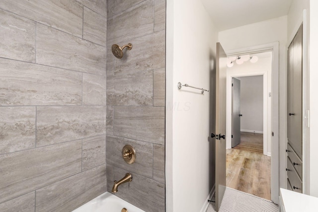full bathroom featuring shower / washtub combination and baseboards