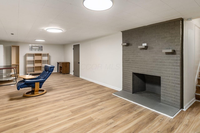 sitting room featuring wood finished floors, baseboards, and a fireplace