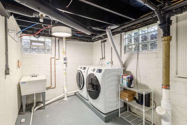 laundry area with washing machine and clothes dryer and plenty of natural light