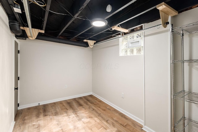 below grade area with wood finished floors and baseboards