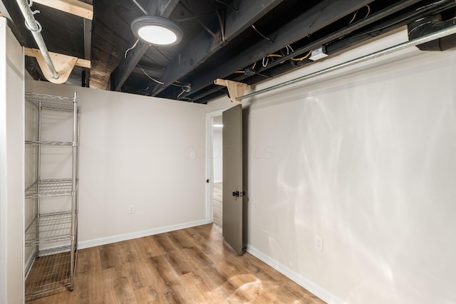 finished below grade area with wood finished floors and baseboards