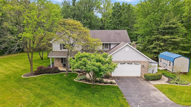 7227 Stemen Rd, Pickerington, OH 43147 - view of front of house featuring driveway, a porch, brick siding, and a front lawn