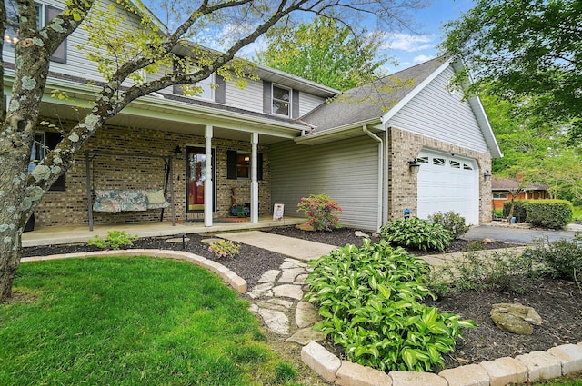 7227 Stemen Rd, Pickerington, OH 43147 - traditional home featuring a porch, brick siding, driveway, a garage, and roof with shingles