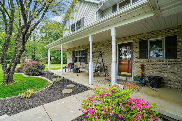 7227 Stemen Rd, Pickerington, OH 43147 - doorway to property featuring covered porch and brick siding