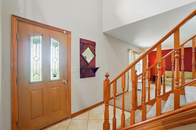 7227 Stemen Rd, Pickerington, OH 43147 - entrance foyer with stairway, light tile patterned floors, baseboards, and a high ceiling