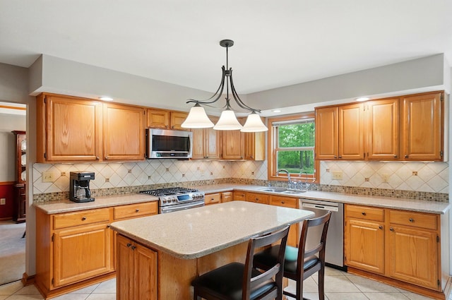 7227 Stemen Rd, Pickerington, OH 43147 - kitchen featuring stainless steel appliances, a sink, a kitchen island, light tile patterned floors, and light stone countertops