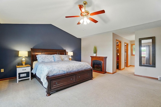 7227 Stemen Rd, Pickerington, OH 43147 - bedroom with light carpet, vaulted ceiling, baseboards, a glass covered fireplace, and ceiling fan