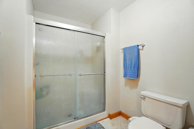 7227 Stemen Rd, Pickerington, OH 43147 - bathroom with toilet, a stall shower, baseboards, and tile patterned floors