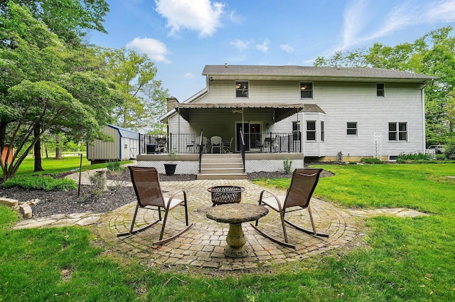 7227 Stemen Rd, Pickerington, OH 43147 - rear view of property with an outdoor fire pit, a patio, a deck, a storage shed, and a yard