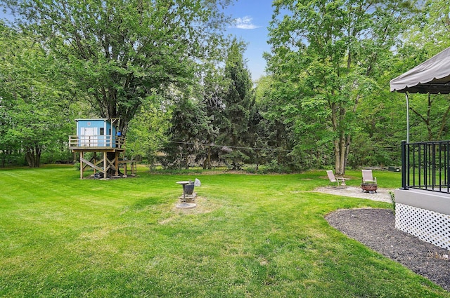 7227 Stemen Rd, Pickerington, OH 43147 - view of grassy yard with a fire pit
