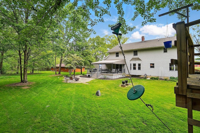 7227 Stemen Rd, Pickerington, OH 43147 - rear view of property with a fire pit, a patio area, a lawn, and a chimney