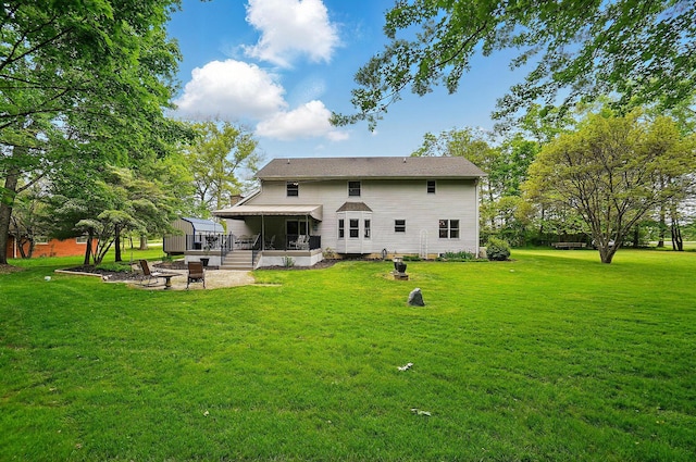7227 Stemen Rd, Pickerington, OH 43147 - rear view of property featuring a sunroom, a lawn, and a fire pit
