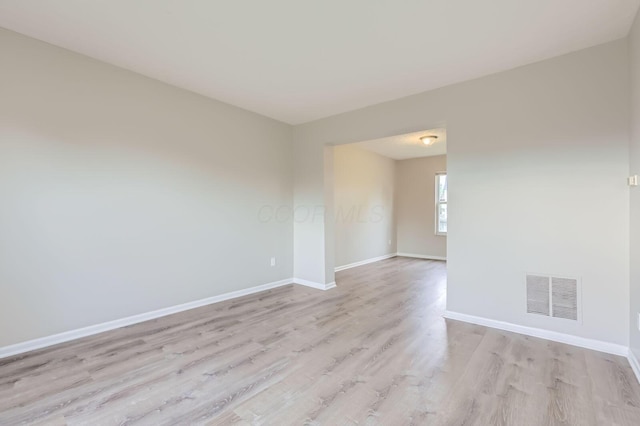 empty room featuring light wood-style floors and baseboards