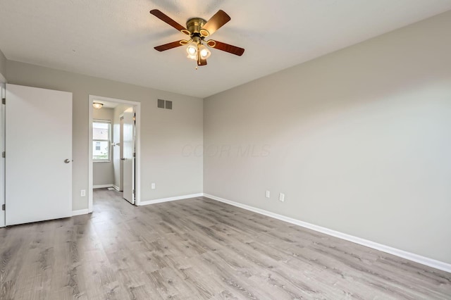empty room with light wood-style floors, ceiling fan, and baseboards