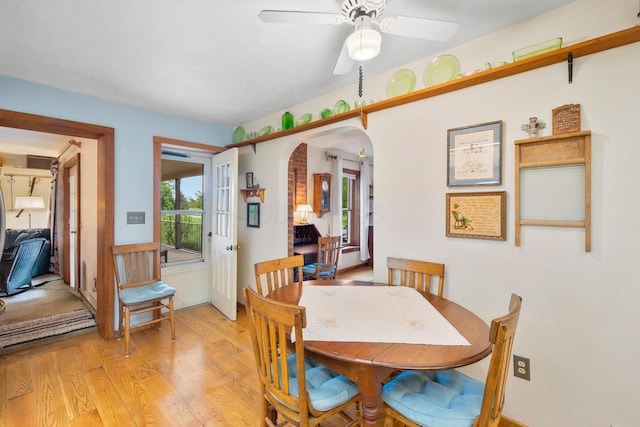 13535 Vans Valley Rd, Galena, OH 43021 - dining space with arched walkways, ceiling fan, and light wood-type flooring