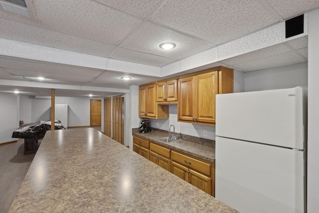 7235 Ballou Rd, Heath, OH 43056 - kitchen with freestanding refrigerator, dark countertops, a sink, a drop ceiling, and recessed lighting