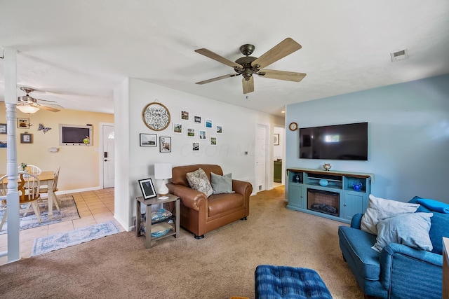 19 Vaughn Rd, Delaware, OH 43015 - living room with a ceiling fan, carpet floors, and a fireplace