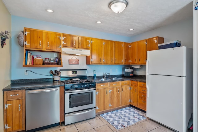 19 Vaughn Rd, Delaware, OH 43015 - kitchen featuring appliances with stainless steel finishes, under cabinet range hood, brown cabinetry, light tile patterned flooring, and recessed lighting