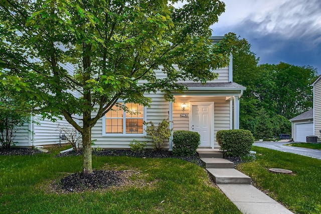 3983 Summerstone Dr, Columbus, OH 43230 - view of property hidden behind natural elements featuring cooling unit, a front lawn, and a garage