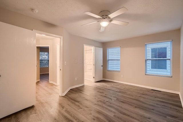 3983 Summerstone Dr, Columbus, OH 43230 - unfurnished bedroom featuring wood finished floors, baseboards, a ceiling fan, and a textured ceiling