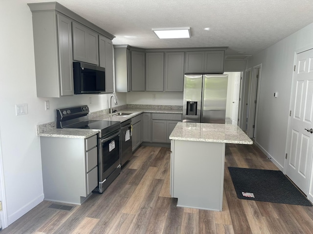 19966 Happy Hollow Rd, Laurelville, OH 43135 - kitchen with appliances with stainless steel finishes, a sink, gray cabinetry, a center island, and dark wood-style floors