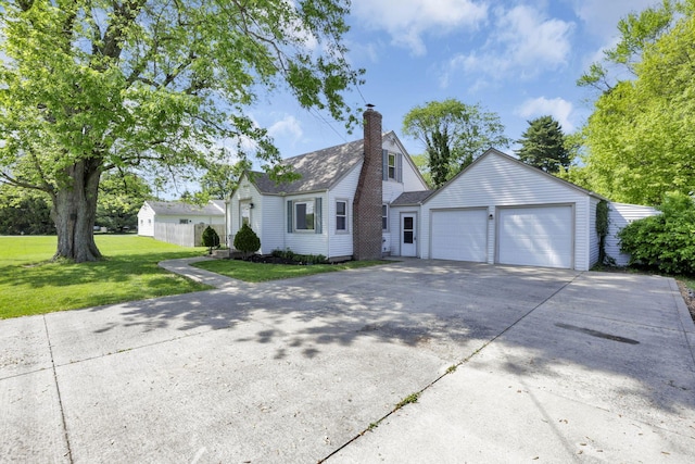 206 Goose Pond Rd, Newark, OH 43055 - view of front facade with a chimney, a front yard, an attached garage, and driveway