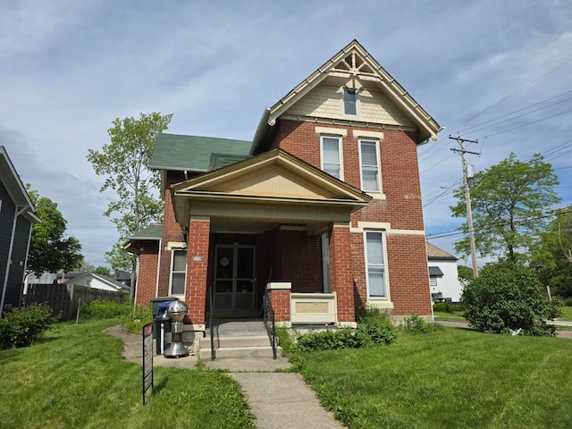195 N Monroe Ave, Columbus, OH 43203 - victorian home with covered porch, brick siding, and ac unit