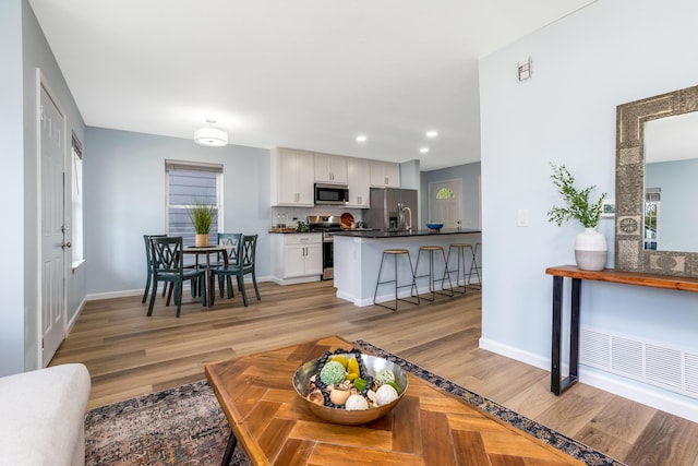 225 Reeb Ave, Columbus, OH 43207 - living area featuring light wood-style flooring and recessed lighting