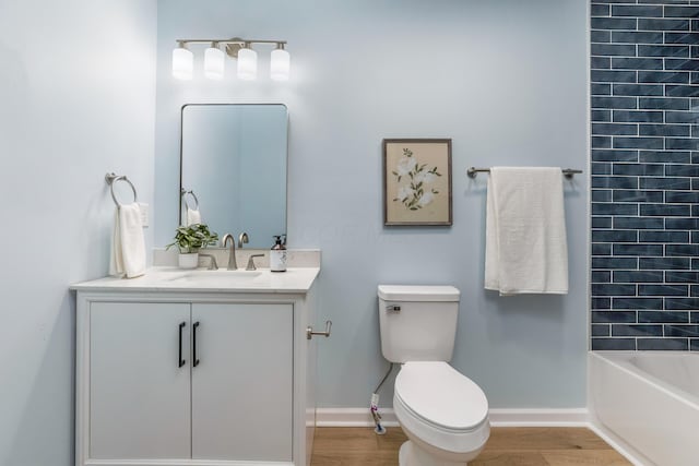225 Reeb Ave, Columbus, OH 43207 - bathroom featuring vanity, wood finished floors, and bathtub / shower combination