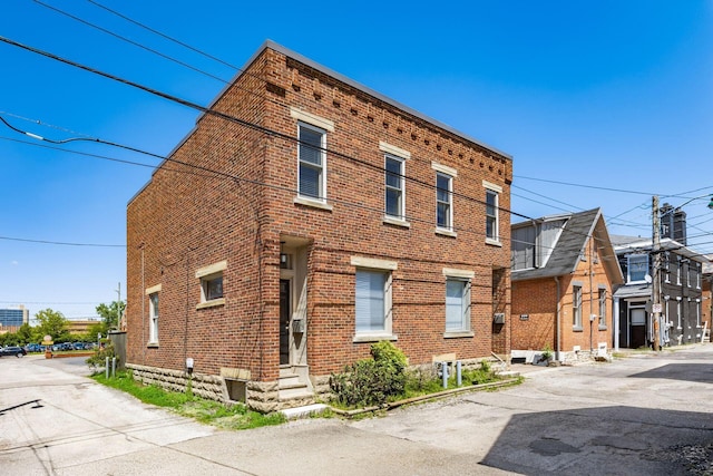 view of side of home featuring brick siding